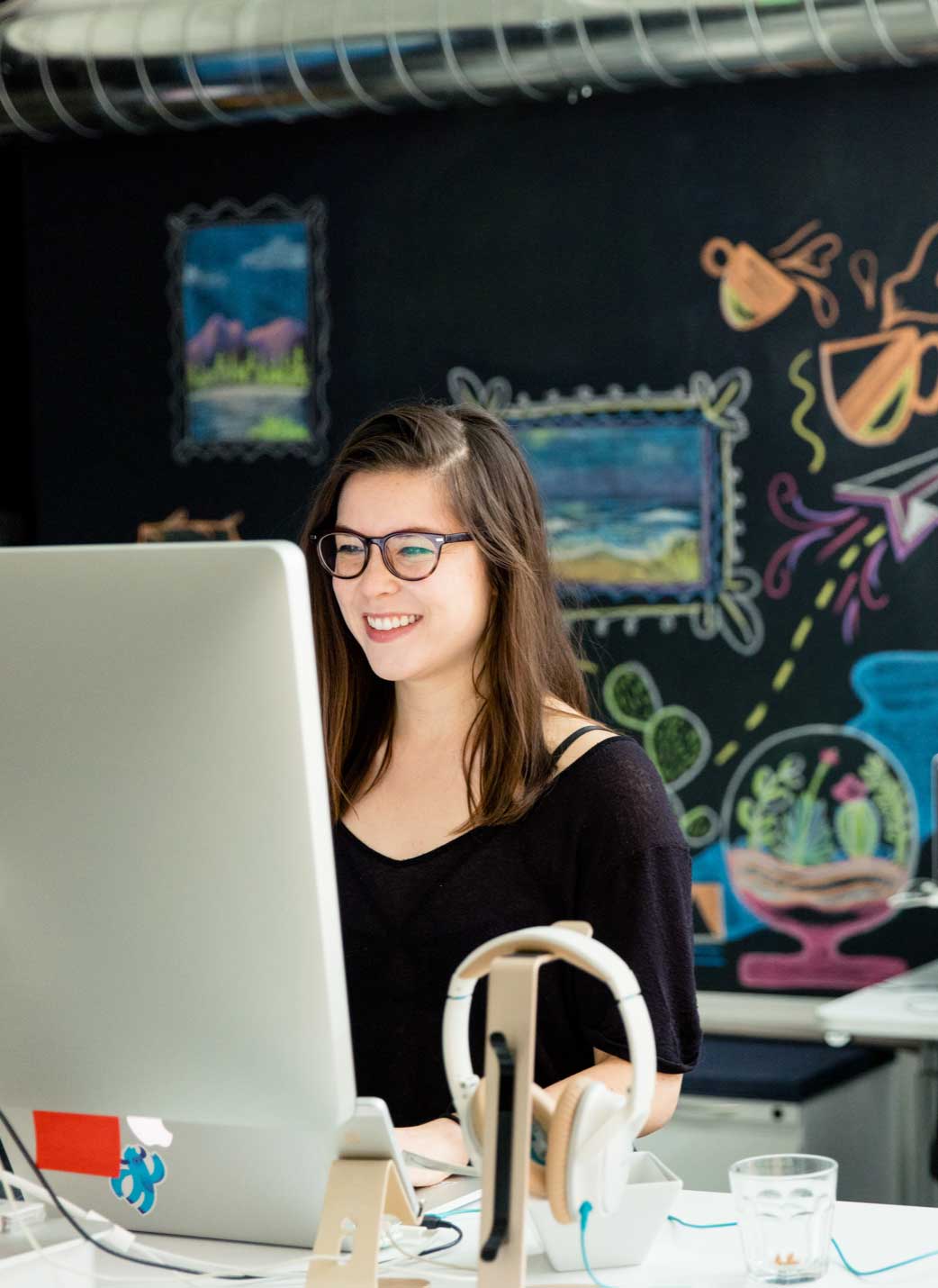 Photo of a person at a computer doing work