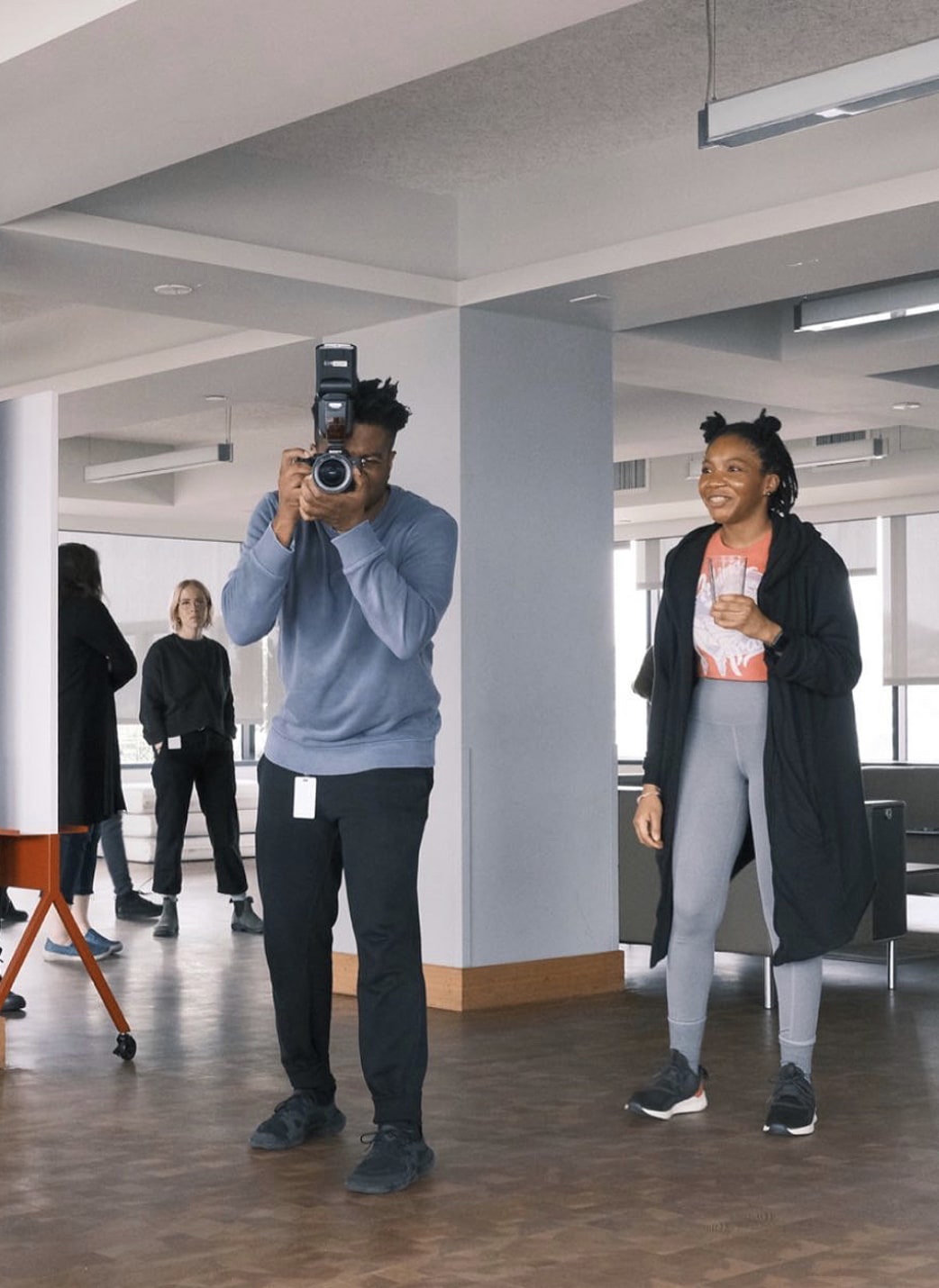 A photo of one person taking a photo while another laughs