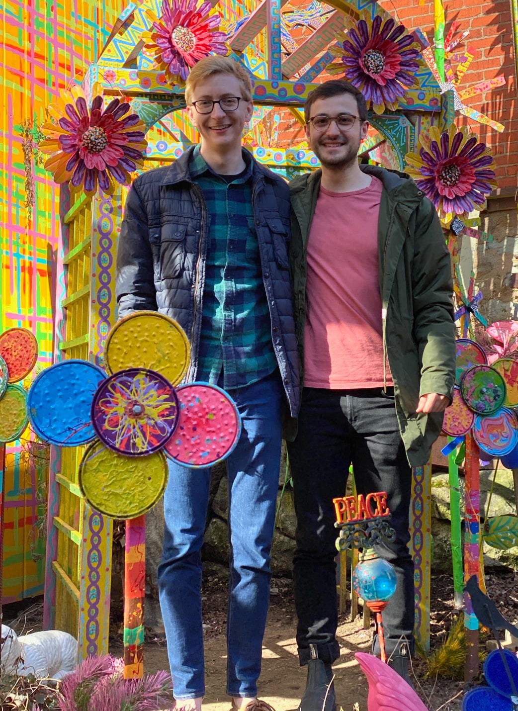 Photo of two designers in front of a festive backdrop